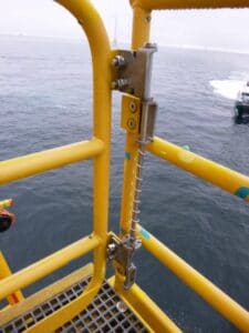 spring assisted closer on offshore platform access gate