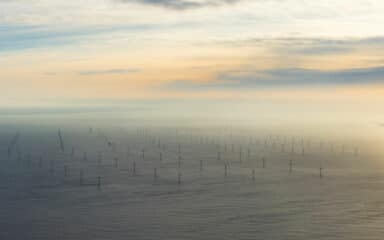 Offshore wind farm from above at sunset